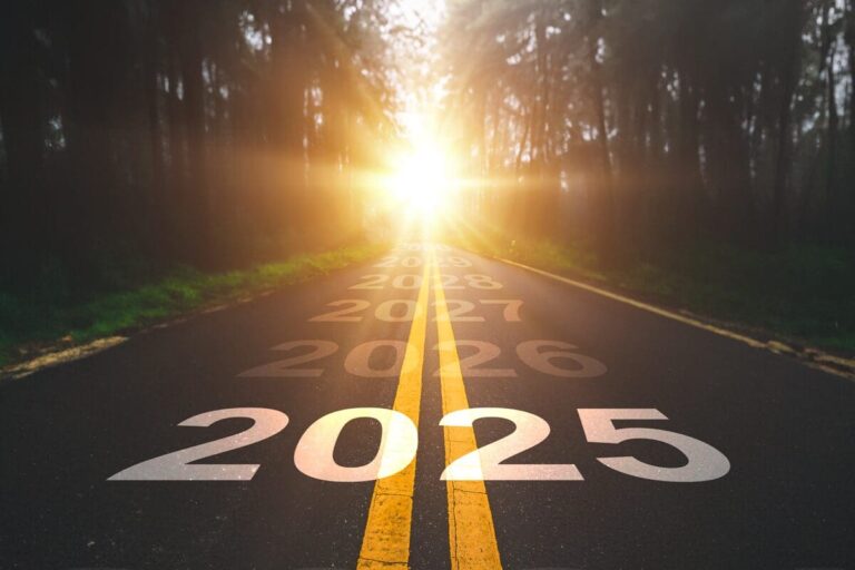 An image of a country road driving through a forest, with the year 2025 set ahead - photo